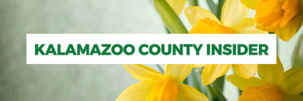 Kalamazoo County Insider in bold black letters centered in a white rectangle overlaid on fall foliage